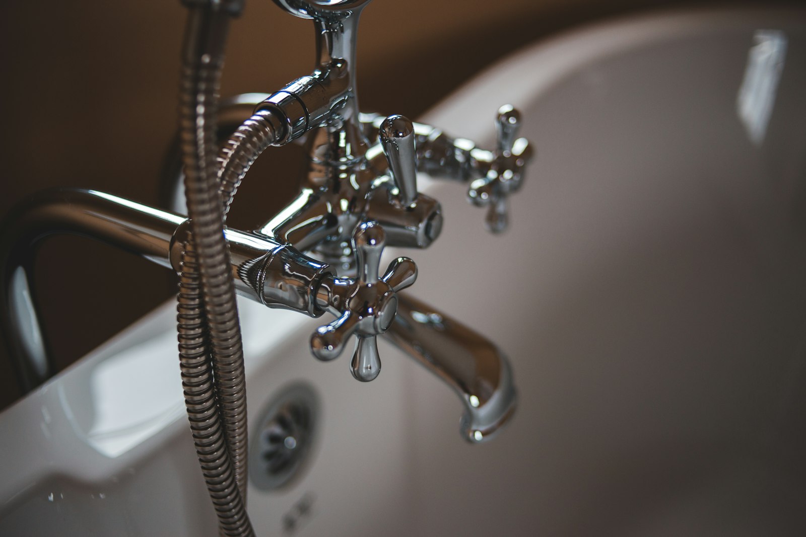 Close-up of a chrome bath faucet and fixtures