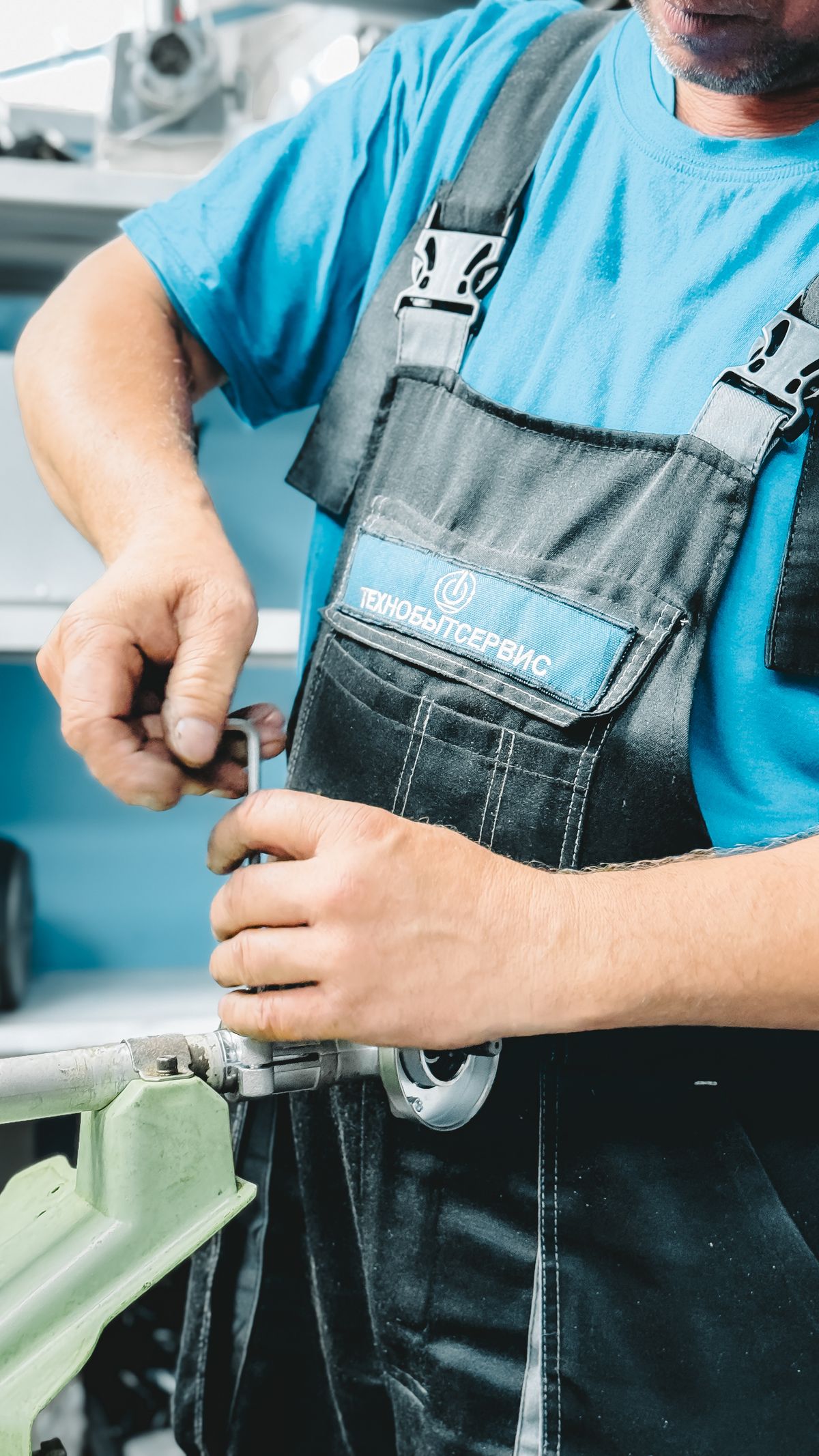 A plumber locating and repairing a pipe leak with a wrench