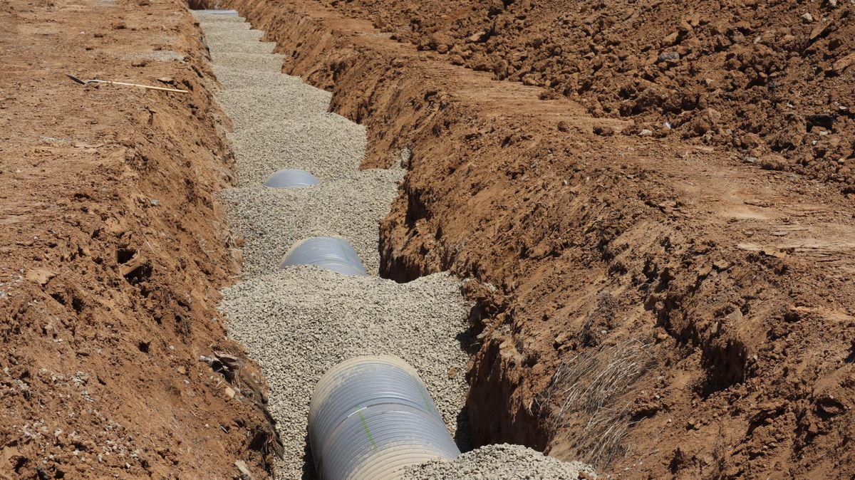 A large sewer drainage pipe in an open trench